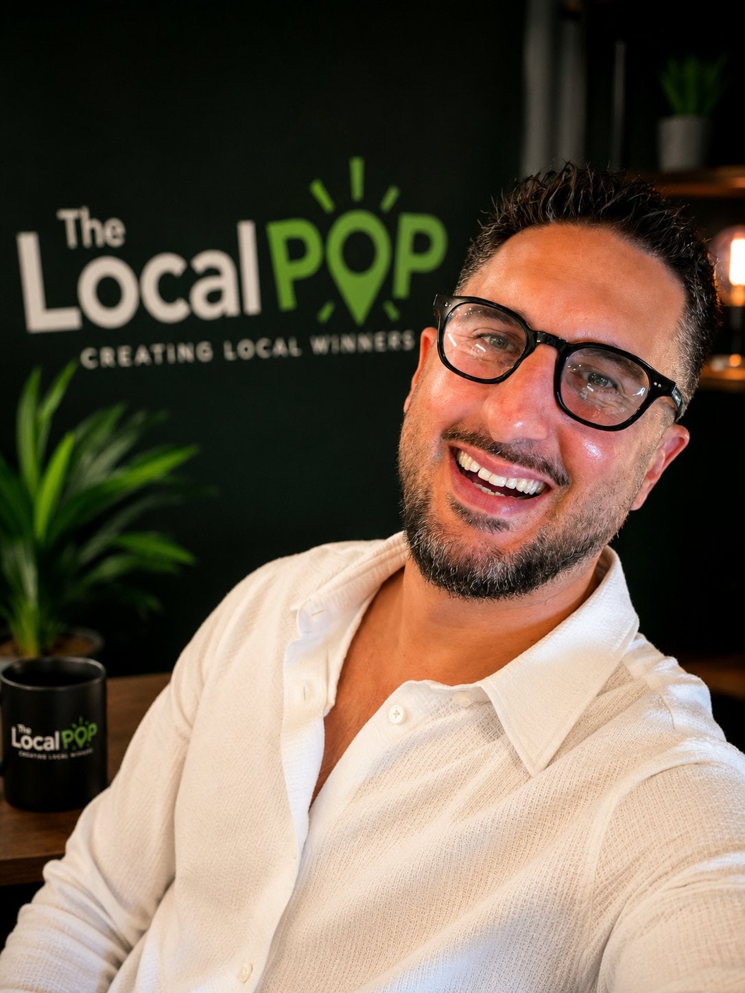 The founder of The Local Pop at the branded studio wall